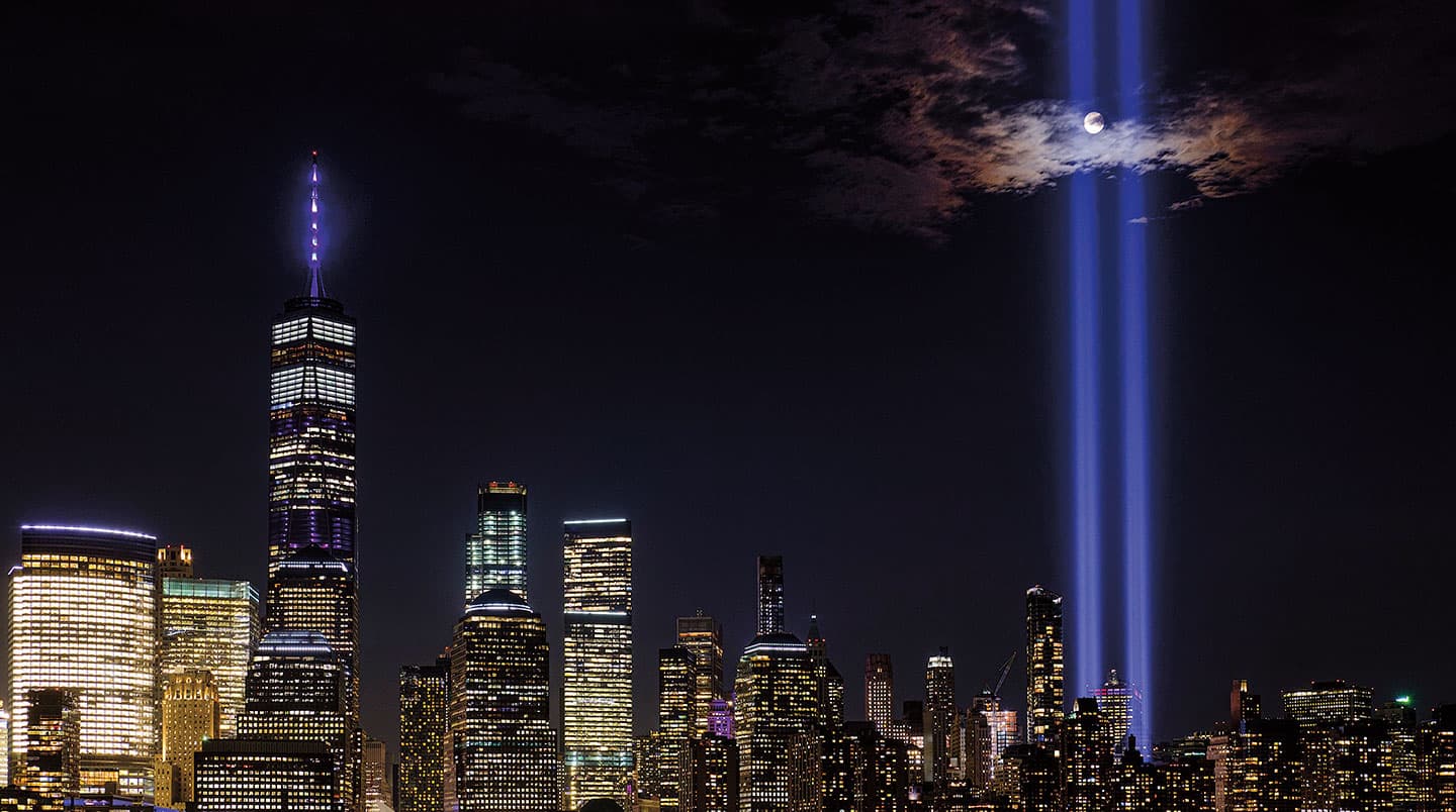 Two beams of light reach to the sky and mark the former location of the twin towers.