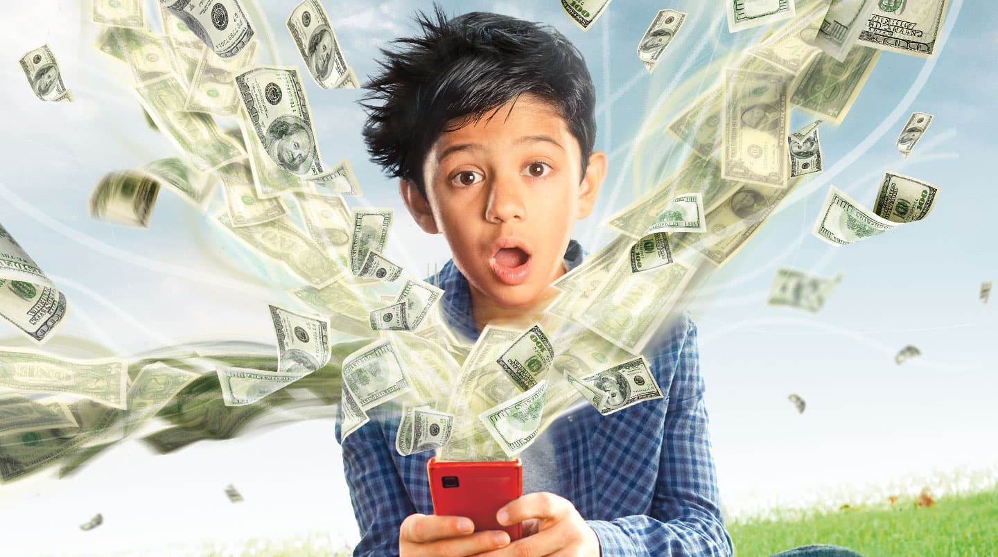 A young boy is shocked as money flies out of his phone