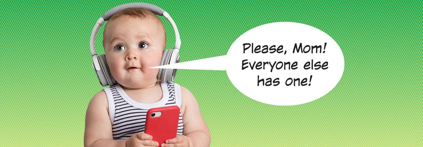 A baby wearing headphones and holding a smartphone.