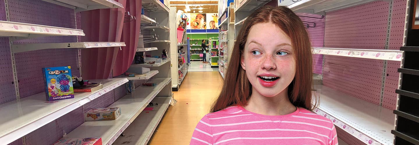 Kid standing in an empty toy aisle