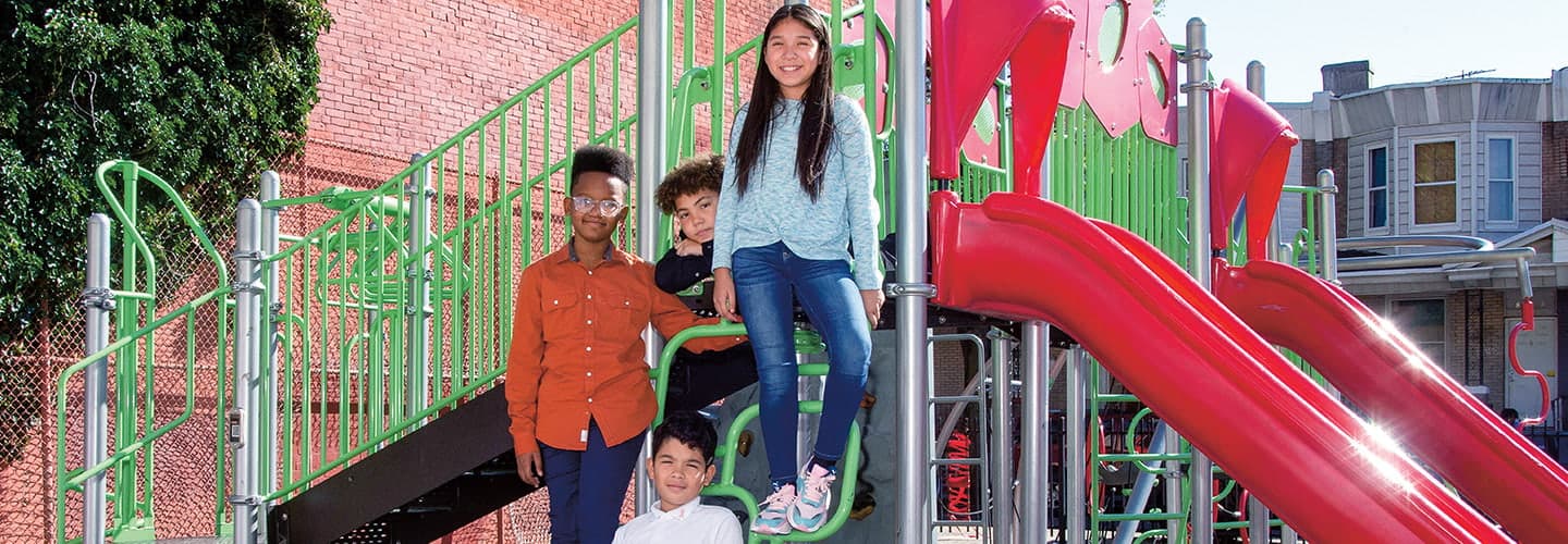 Photo of students posing on a playground