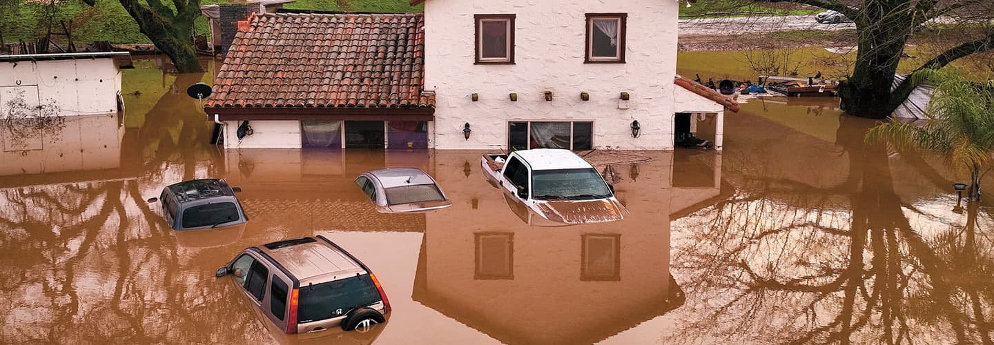 Image of a house and cars flooded