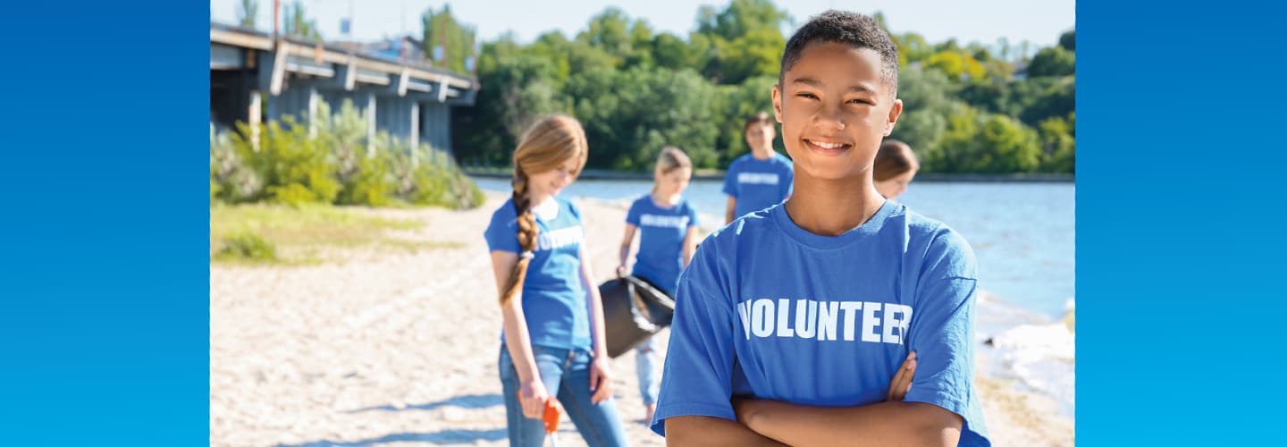 Photo of kids volunteering by a body of water